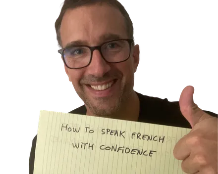 Yann smiling with a thumbs up next to a yellow notepad sheet that reads "How to speak French with confidence"