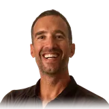 Yann, smiling at the camera, in a dark polo shirt